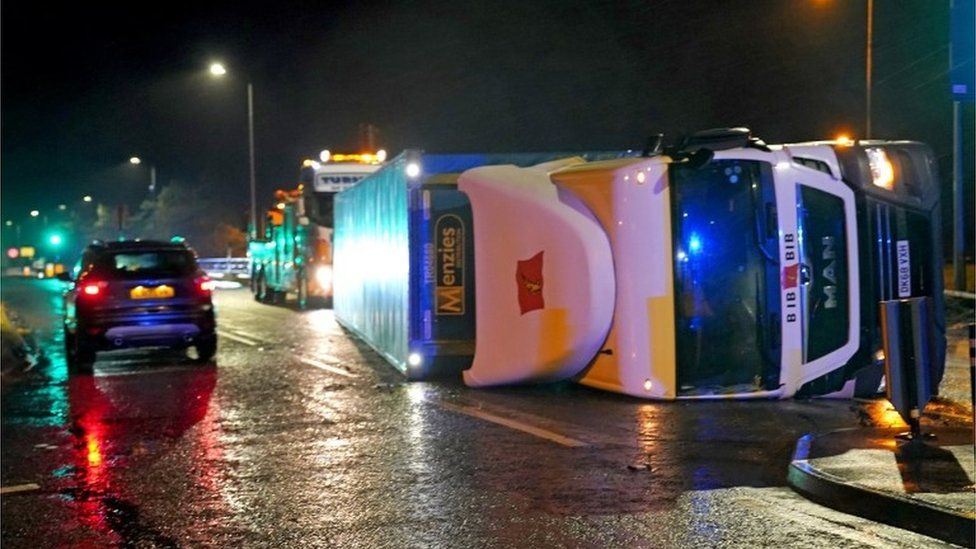 A lorry blown over in high winds blocks the A179 near Hartlepool, County Durham,