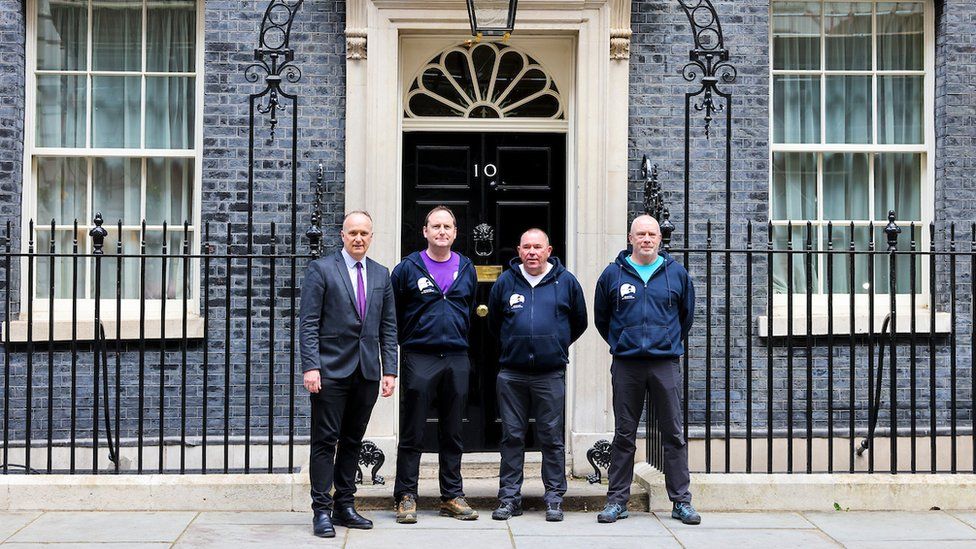 The 3 Dads outside the front door of 10 Downing Street alongside Penrith and the Border MP Neil Hudson