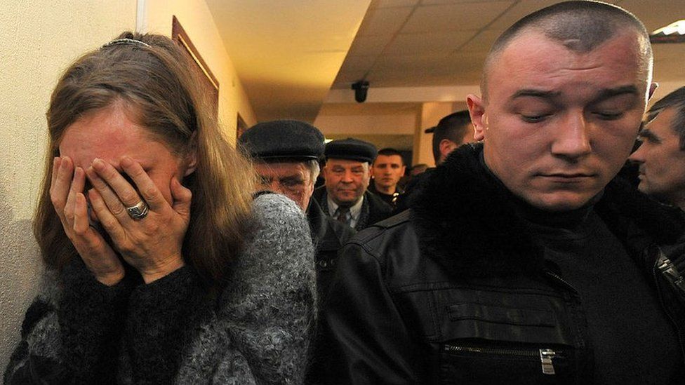 A woman cries after a family member is sentenced to death in a Belarus court