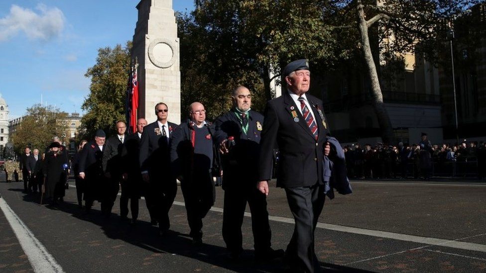 Former military members walk past the Cenotaph