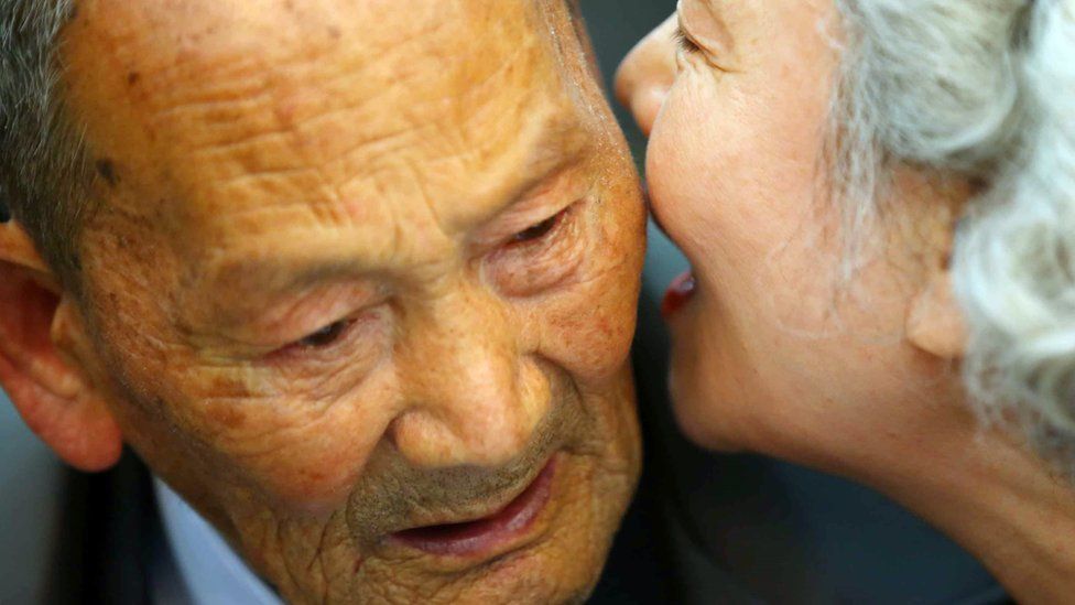 South Korean Lee Jeong-Suk (R), 68, whispers to her North Korean father Ri Heung-Jong (L), 88, during a separated family reunion meeting at the Mount Kumgang resort on the North"s southeastern coast on October 20, 2015.