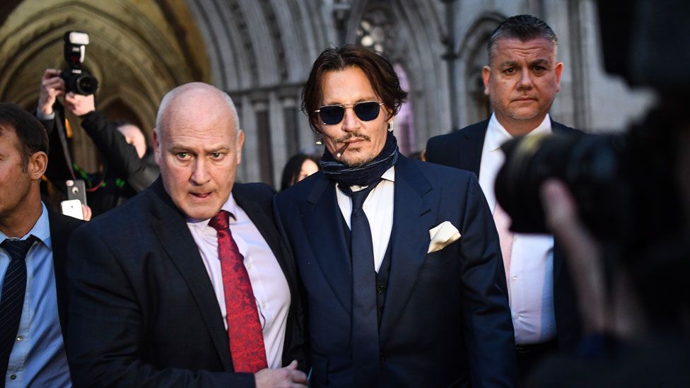 Johnny Depp (centre) leaves the Royal Courts of Justice in London on 26 February 2020