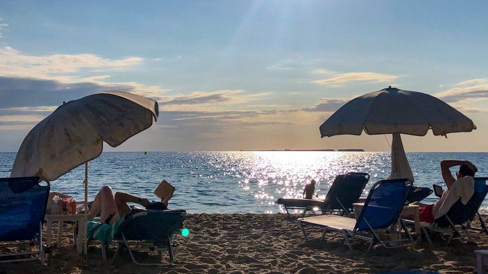 Holidaymakers at the beach of Makris Gialos Beach, Greece