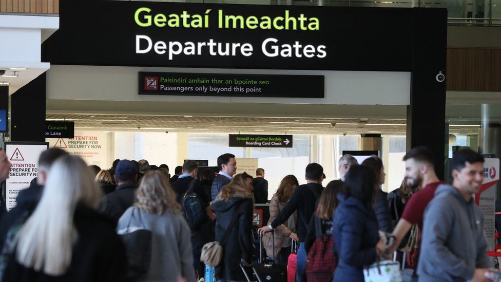 People gathering at the entrance to the departure gates area at Dublin Airport