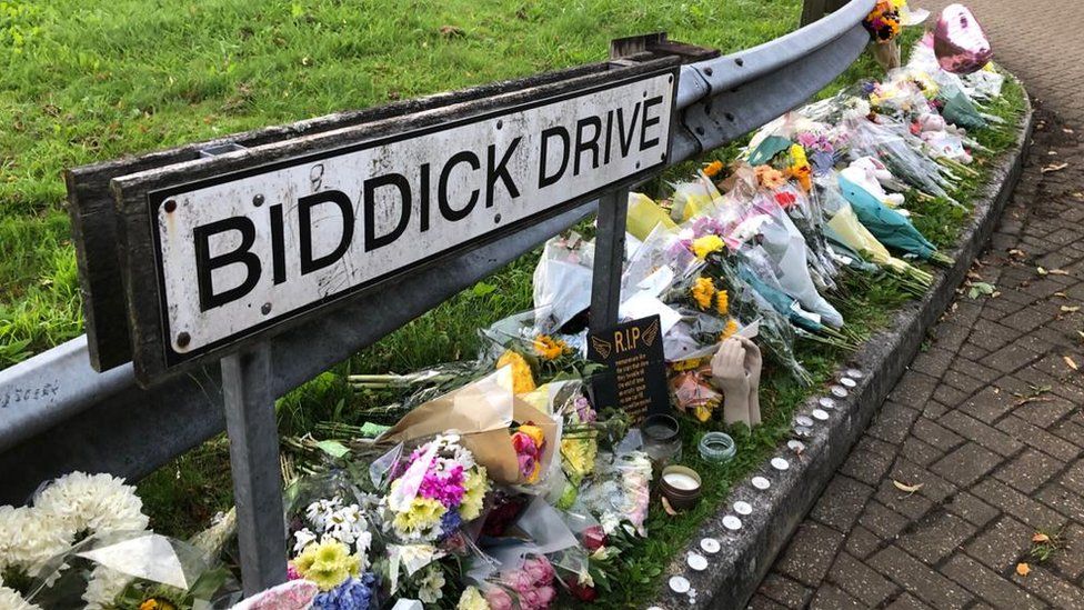 Biddick Drive sign with flowers underneath