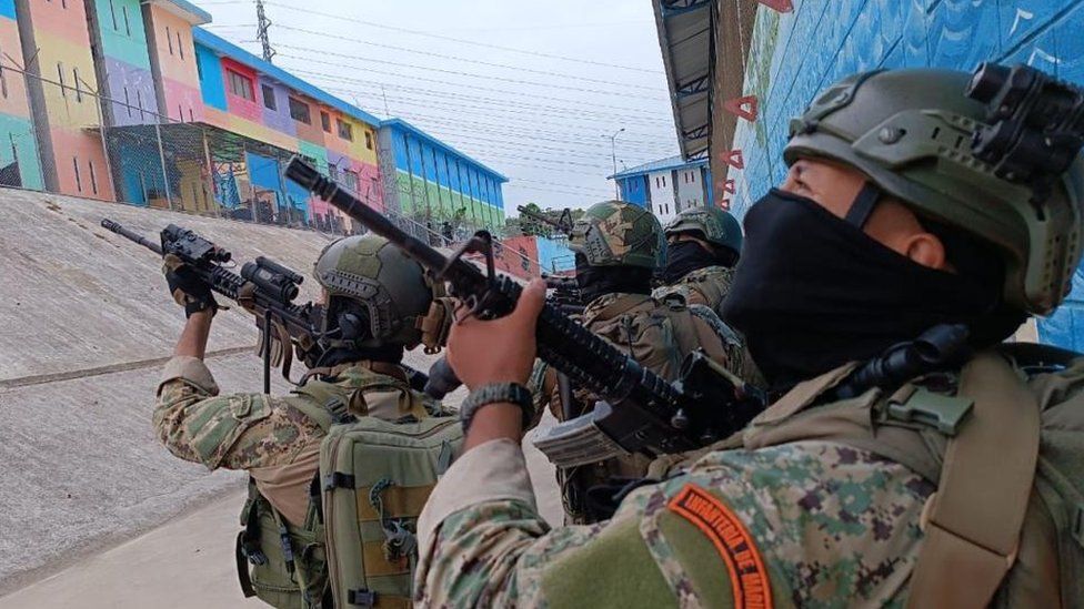 A handout photo made available by the Armed Forces of Ecuador shows Marine Infantry soldiers as they carry out an operation after a riot at the Litoral Regional prison