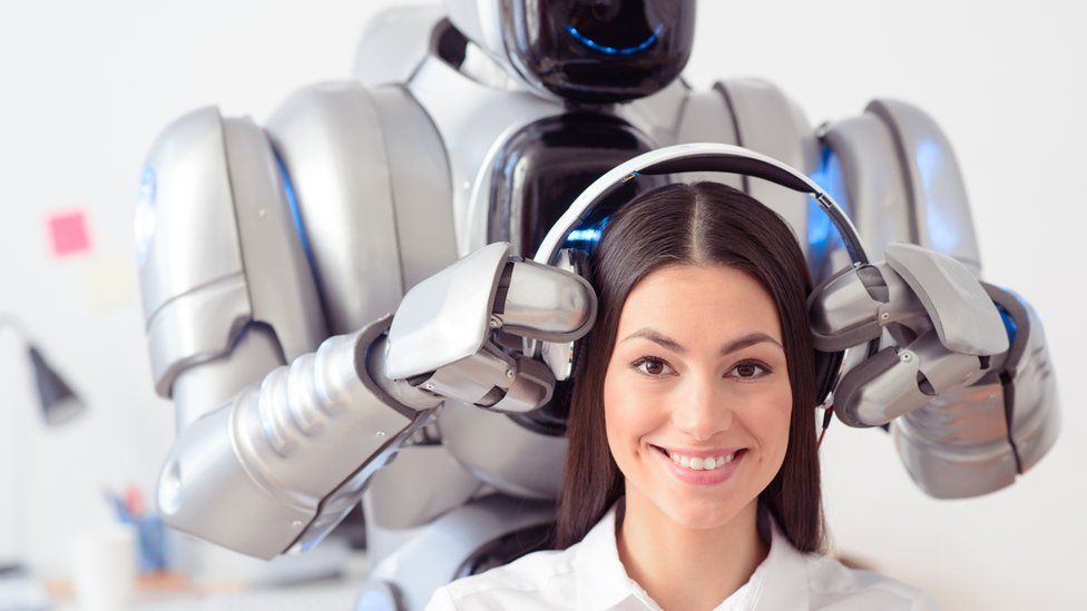 Smiling robot putting headphones on smiling woman