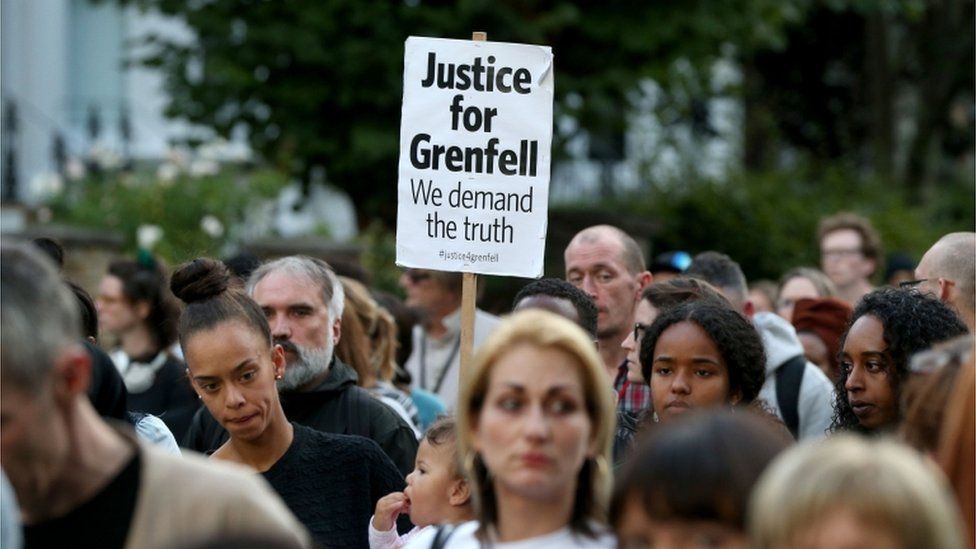 A silent march to pay respect to those killed in the Grenfell Tower disaster makes its way down Ladbroke Grove, London