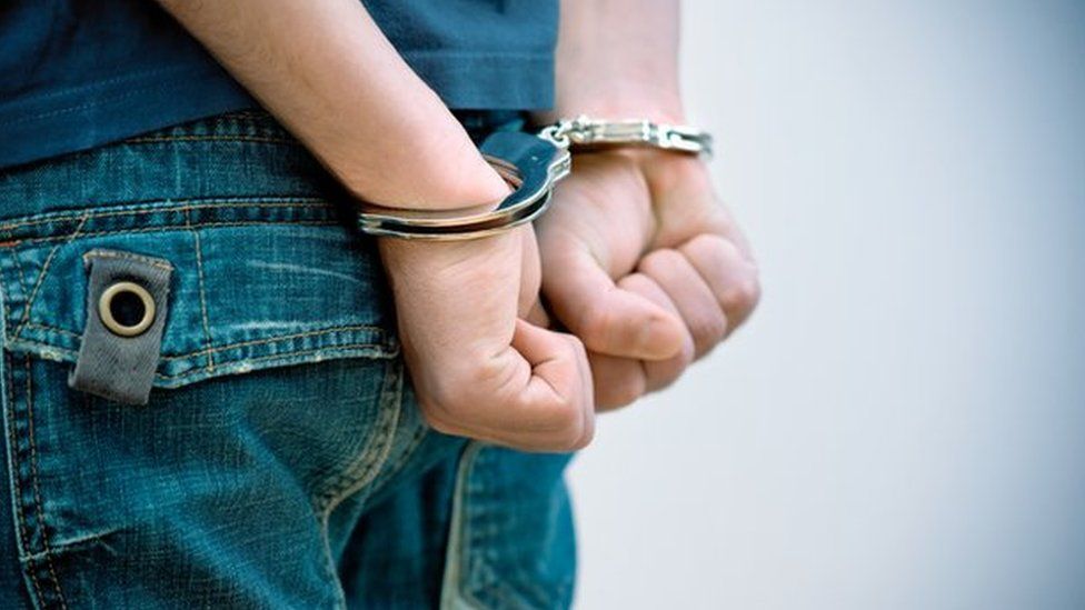 Teenager in handcuffs