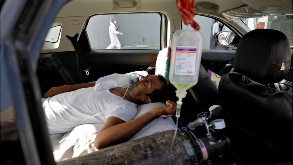 A patient with breathing problems lies inside a car while waiting to enter a COVID-19 hospital for treatment, amidst the spread of the coronavirus disease (COVID-19), in Ahmedabad, India, April 22,