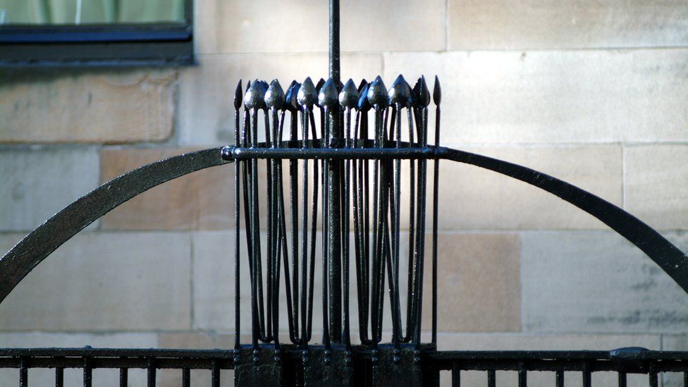 Railings featuring a sequence of Japanese-influenced symbols on stalks