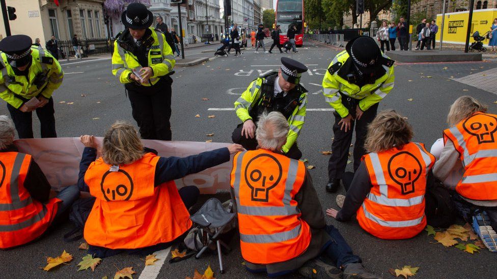 Police with Just Stop Oil protesters in London in October 2022