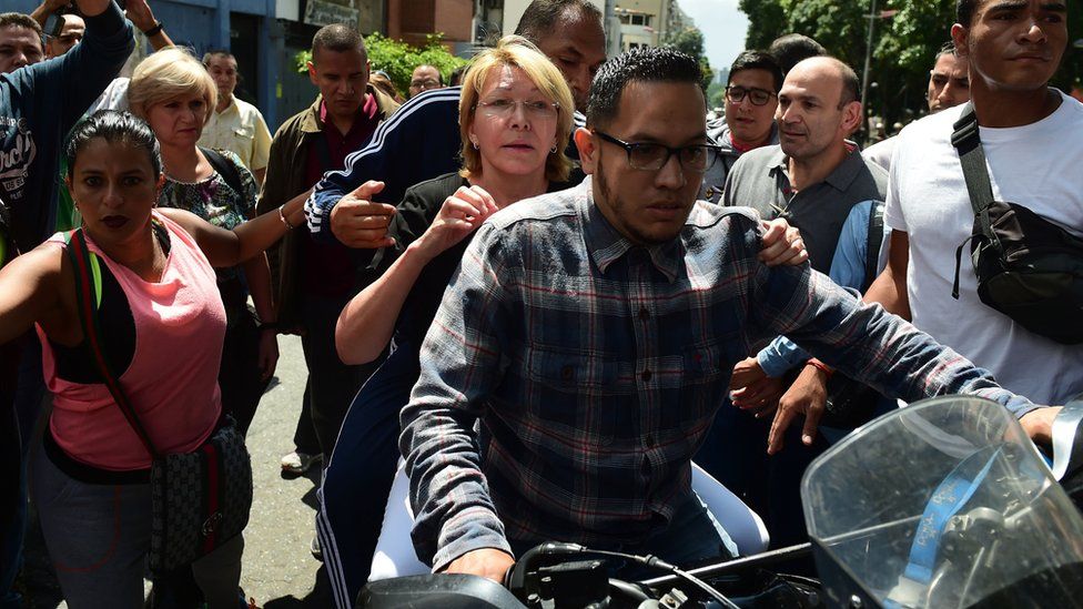 Venezuela's chief prosecutor Luisa Ortega is seen on a motorbike during a flash visit to the Public Prosecutor's office in Caracas