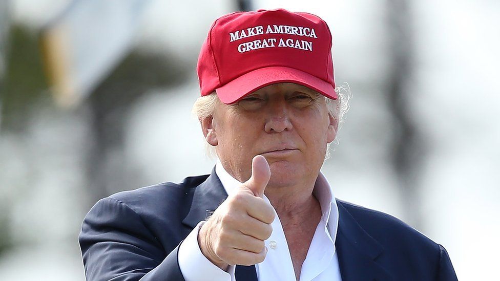 Trump does a thumbs up wearing 'Make America Great Again' hat