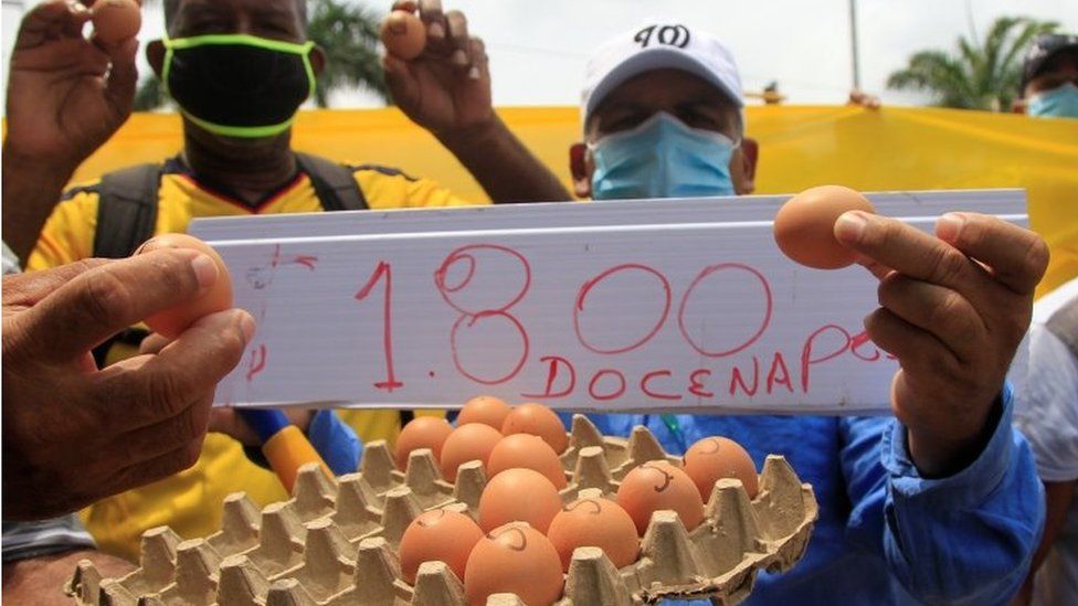 Protesters show eggs in reference to the controversy over the statements of the Minister of Finance Alberto Carrasquilla in which he minimized and did not know the price of this product of the basic food basket during the national strike day, in Cartagena, Colombia, 28 April 2021.