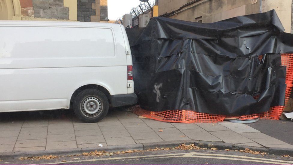 Black covering and a builder's van