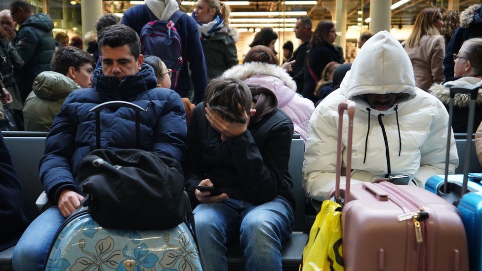 Passengers wait on the concourse at the entrance to Eurostar in St Pancras International station, central London, after high-speed services between London and Ebbsfleet were cancelled because of flooding in a tunnel under the Thames.
