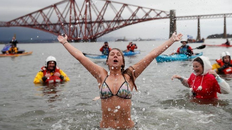 Swimmers participate in the New Year"s Day Loony Dook swim at South Queensferry in Scotland
