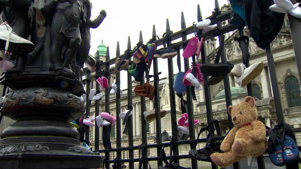 Children's shoes were tied to gates of Belfast City Hall by campaigners