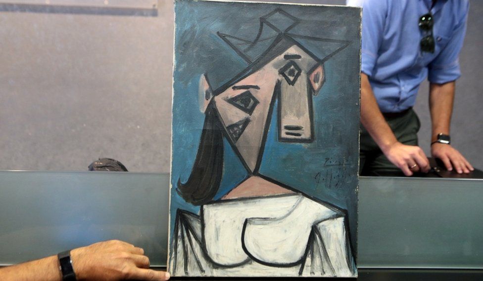 Greek Police officers presents the stolen Picasso and Mondrian paintings, at a press conference, in Athens, Greece, 29 June 2021.