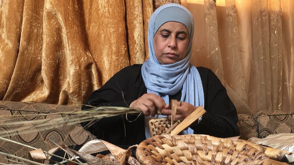 Raeda Jaryan working on her hand-crafted baskets