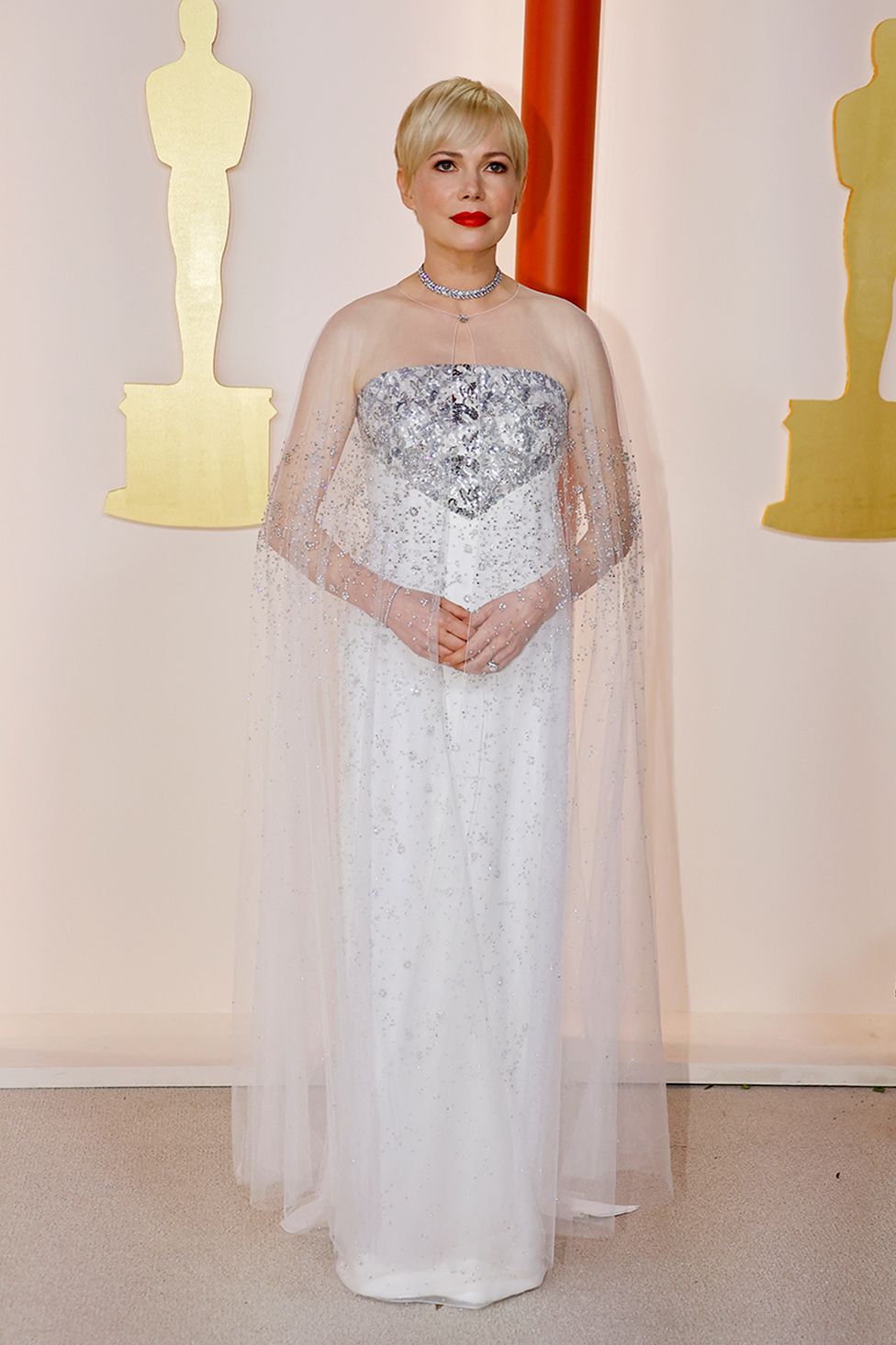 Michelle Williams poses on the champagne-colored red carpet during the Oscars arrivals at the 95th Academy Awards in Hollywood, Los Angeles, California, U.S., March 12, 2023