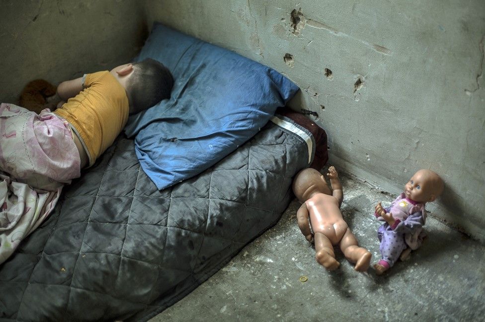 Nikoloz Beriashuili, aged two-years-old, sleeps in the one room he shares with his mother, father and sister