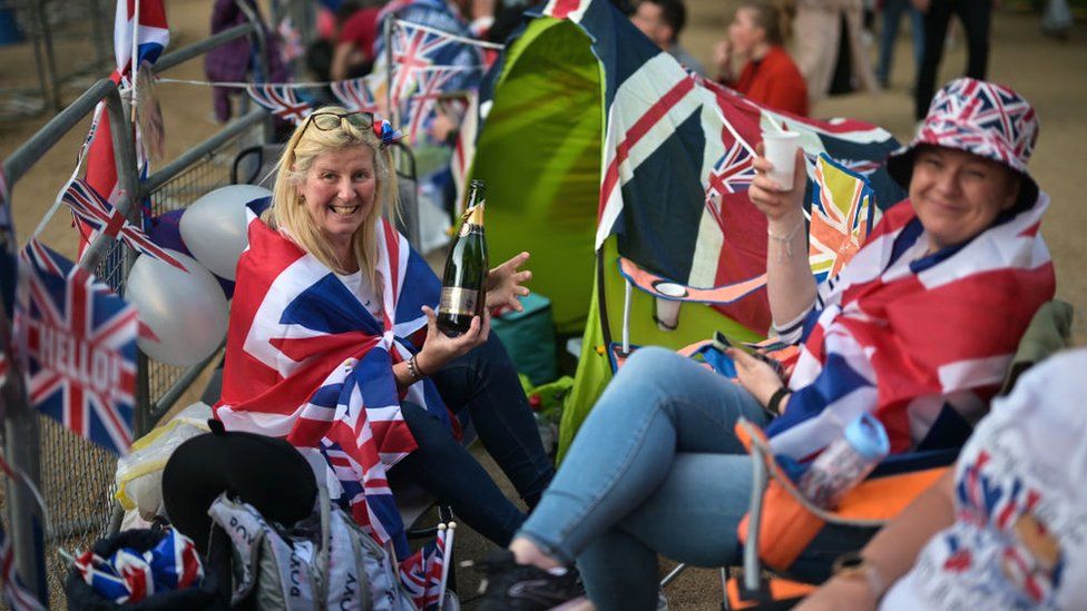 People dressed in Union flags camping on the Mall