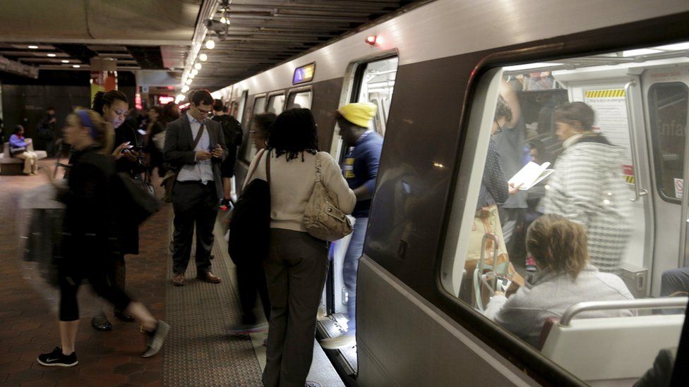 Commuters board a train at the Gallery Place-Chinatown station ahead of a 29-hour shutdown for an emergency safety investigation of power cabling of the entire Washington Metro system in Washington