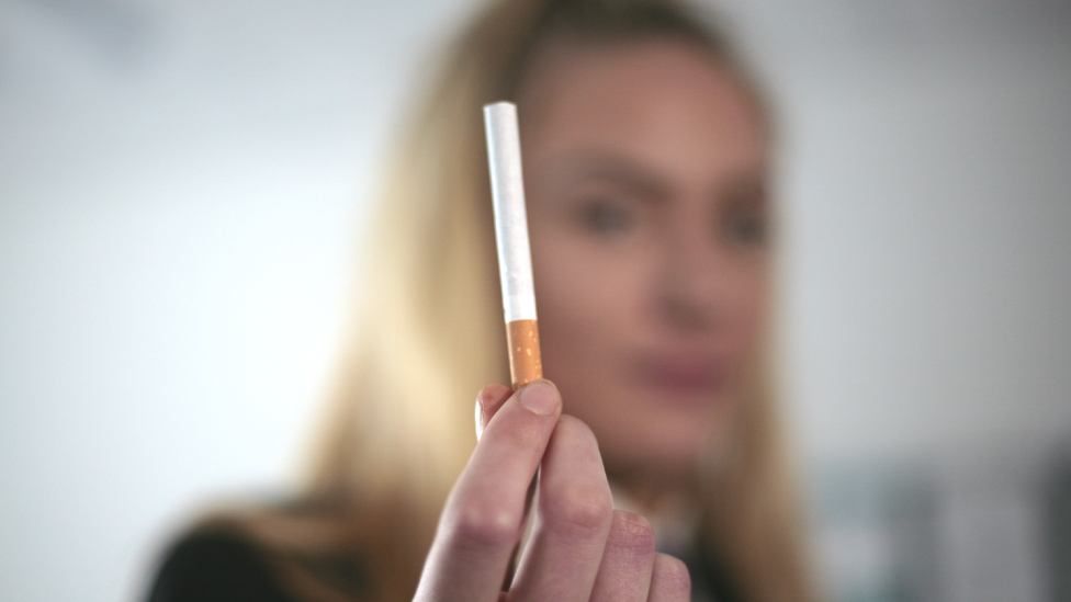 Emma, 17, holding a cigarette