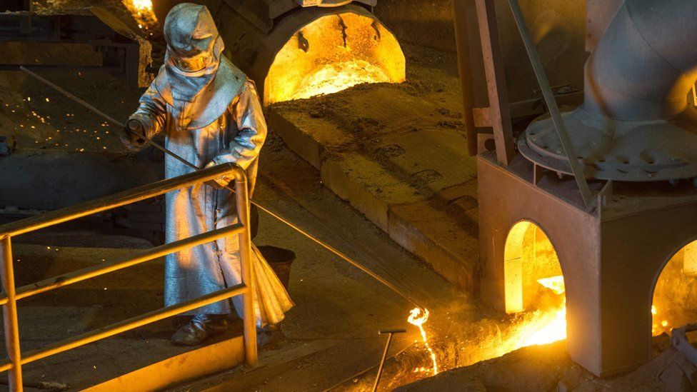 A worker wearing protective clothing agitates molten steel at the Saint-Gobain PAM factory in Pont-A-Mousson, north-eastern France. (April 2016)