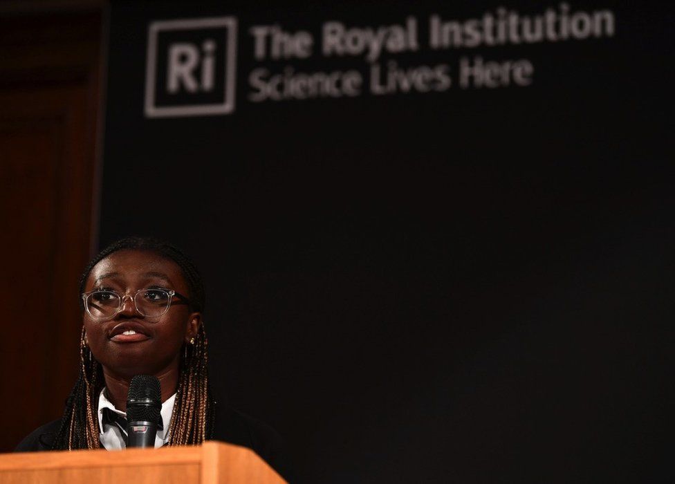 Richael Forson reading her essay at the Royal Institution in London