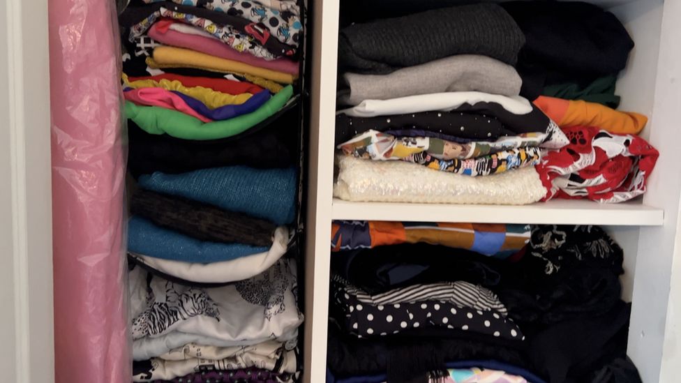 Clothes in a packed wardrobe