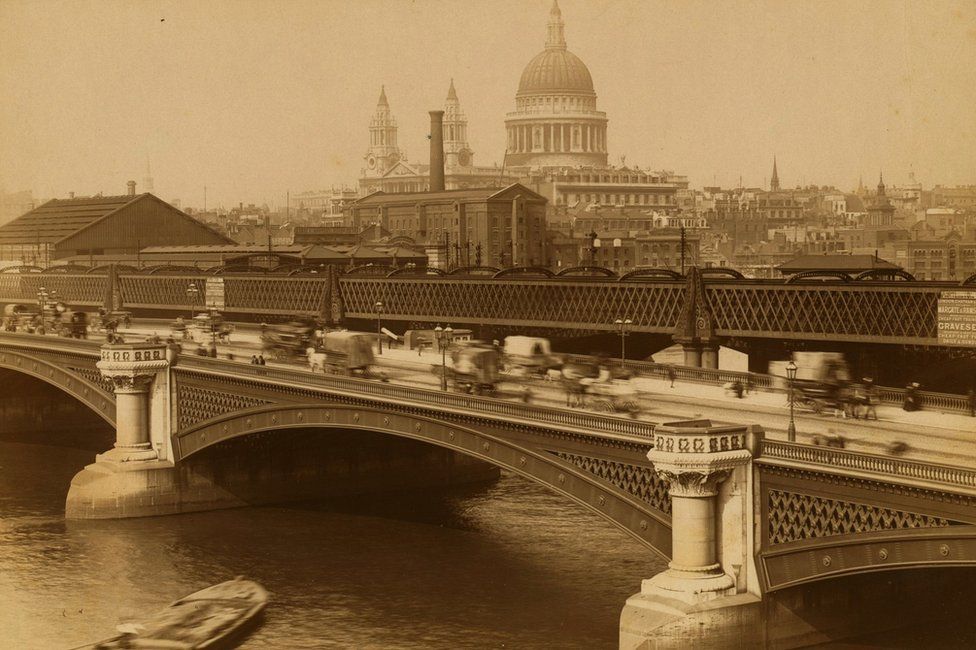 View of carriage and pedestrian traffic on the Blackfriars Bridge with St. Paul's Cathedral in the background, London, 1888.
