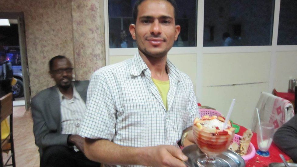 Официант подает десерт в ресторане в Харгейсе, Сомалиленд