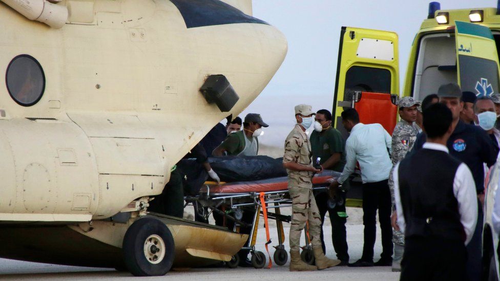 An Egyptian search and rescue crew transfers the body of a victim of a plane crash from a civil police helicopter to an ambulance at Kabrit airport in Suez, 100 kilometres east of Cairo, Egypt, Saturday, Oct. 31, 2015.