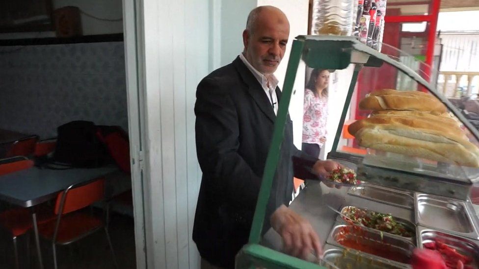 Hakim cooking in his restaurant