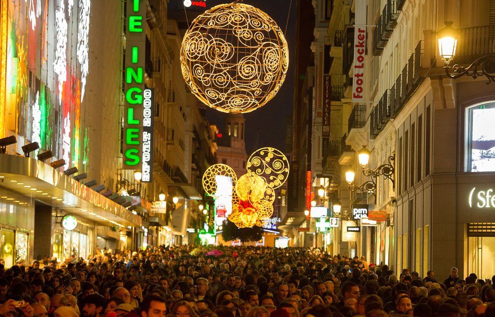 Christmas lights in crowded Madrid high street