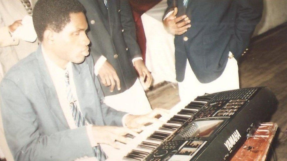 Old picture of Cobhams Asuquo playing the piano