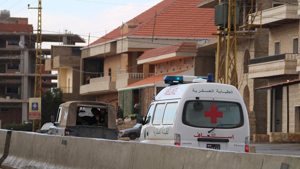 A Lebanese Red Cross ambulance carries the body of Mohammed Hamiya, a Lebanese soldier executed last year by al-Nusra Front, in the village of Labweh (1 December 2015)