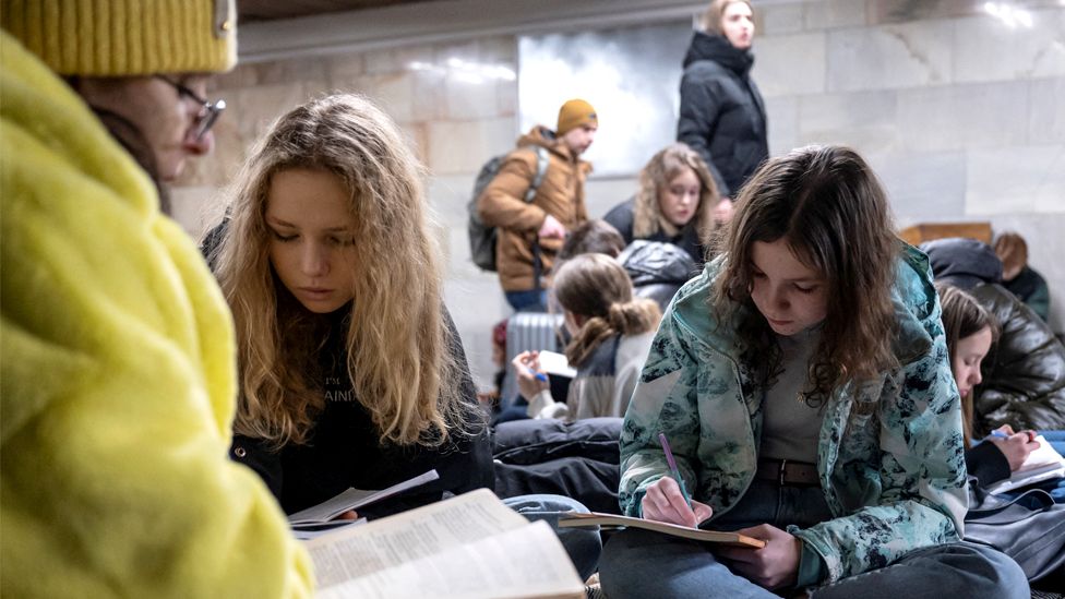 School students attend a lesson as they take shelter inside a metro station during massive Russian missile attacks in Kyiv, Ukraine, on 10 February 2023