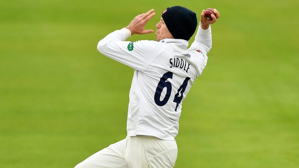 Peter Siddle of Essex, wearing a woolly hat, bowls against Hampshire in the county cricket match on Monday