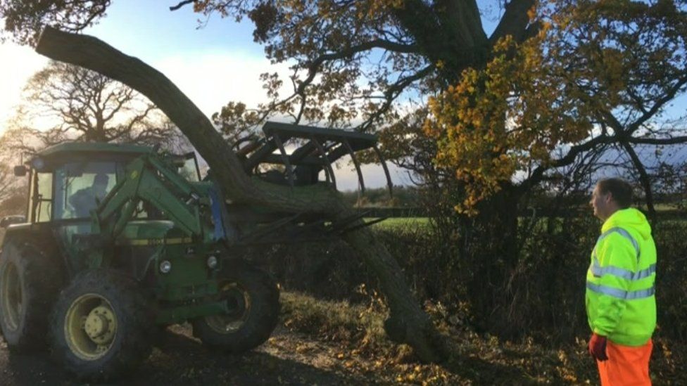 A tractor with a broken branch