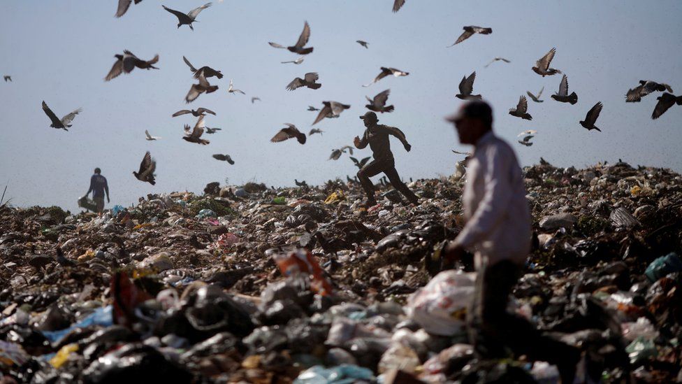 A man runs at Lixao da Estrutural, Latin America's largest rubbish dump, in Brasilia, Brazil, 19 January 2018