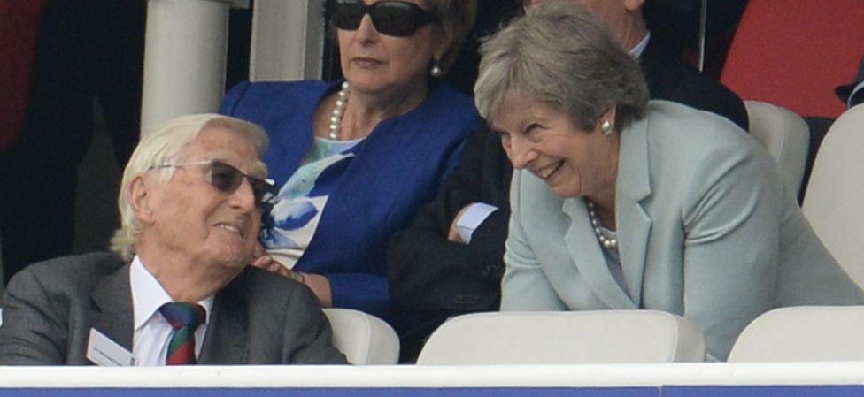 Theresa May chats with Michael Parkinson during the second day of the 1st Natwest Test match between England and Pakistan at Lord's cricket ground on May 25, 2018 in London, England