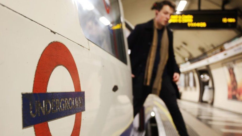 File image of a man disembarking a tube carriage.