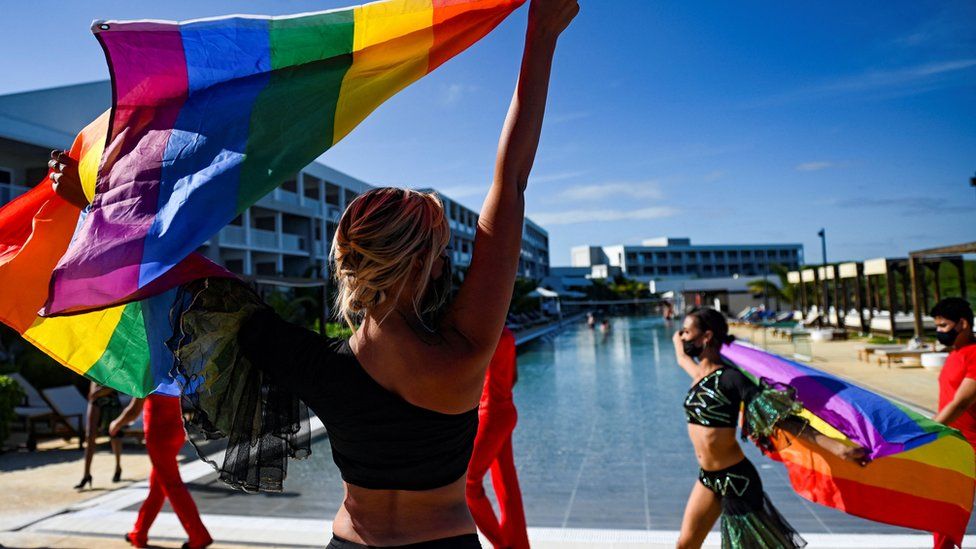 Dancers of the cheerleading team perform with rainbow flags at the Gran Muthu Rainbow Hotel, in Guillermo Key in Ciego de Avila Province, Cuba, on 27 November 2021