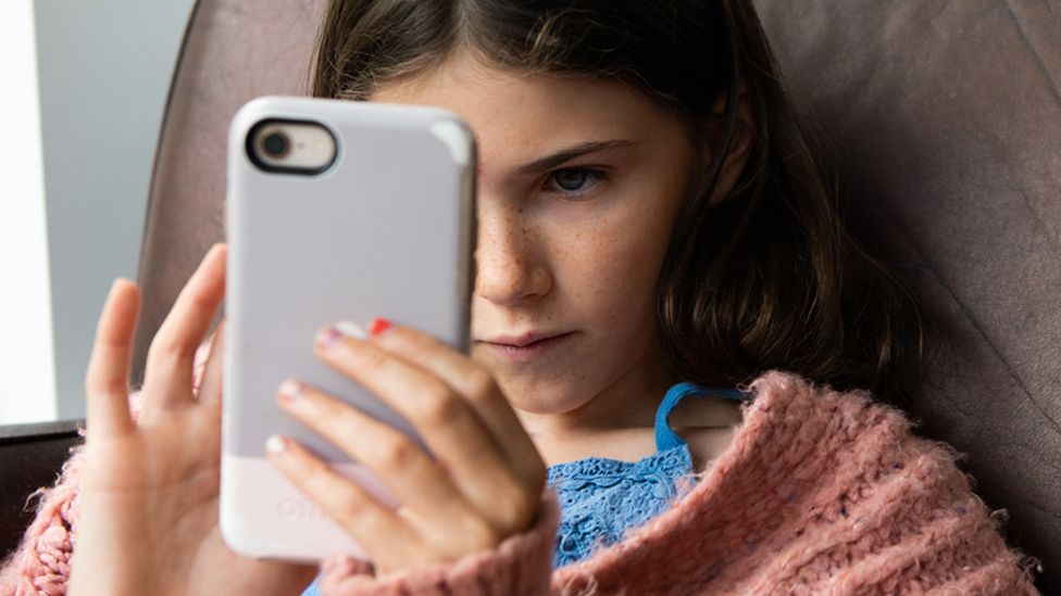Stock image of a girl using a smartphone