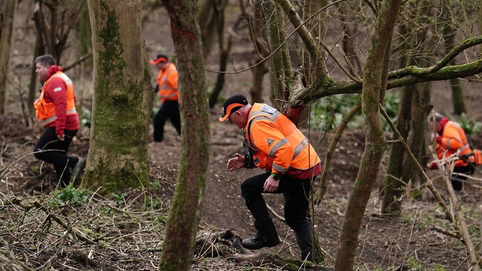 Officers from London Search and Rescue (LONSAR) sweep the area in Wild Park Local Nature Reserve, near Moulsecoomb, Brighton