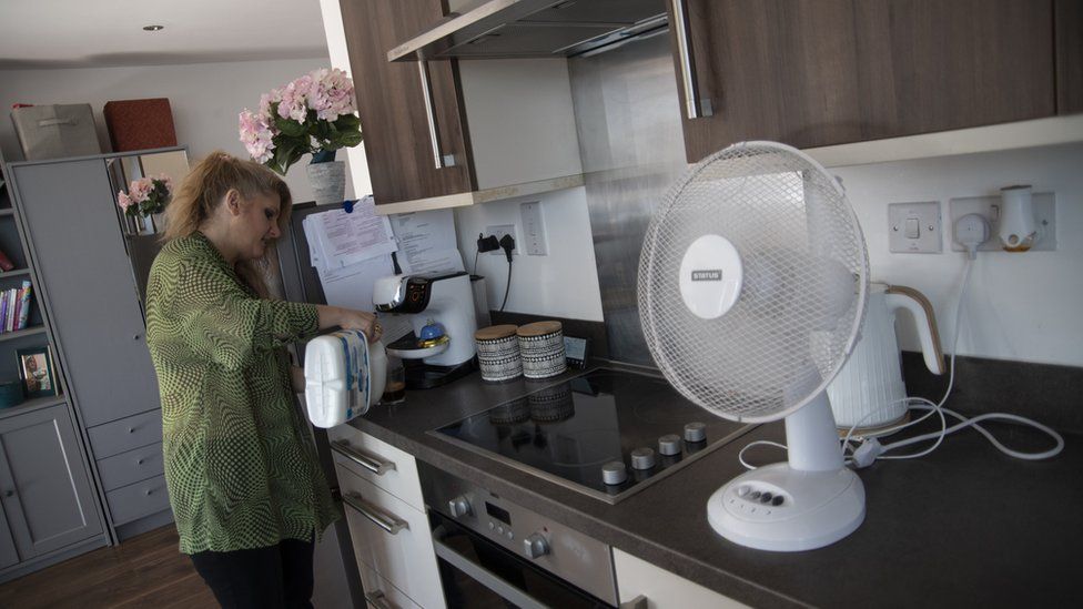 Jorda in her home in Harlsden, London. She is making a coffee in her kitchen